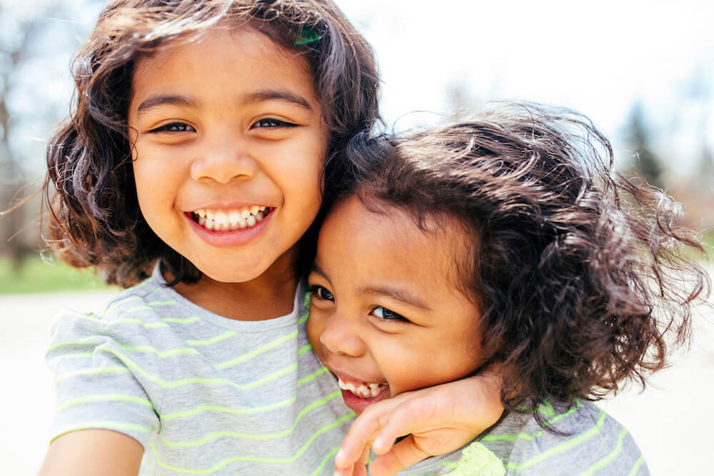 Two girls hugging and smiling