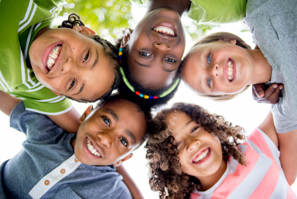 Children smiling in a huddle